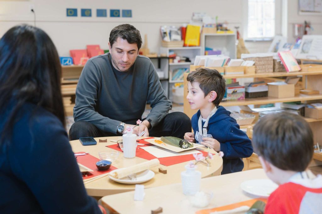 Parent and child make sushi together during a Montessori community event at Guidepost Montessori Mahwah.
