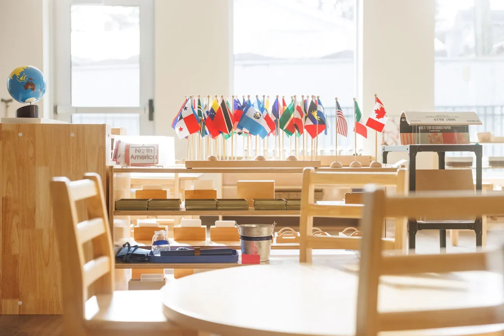 Montessori classroom with geography materials and world flags at Guidepost Montessori.